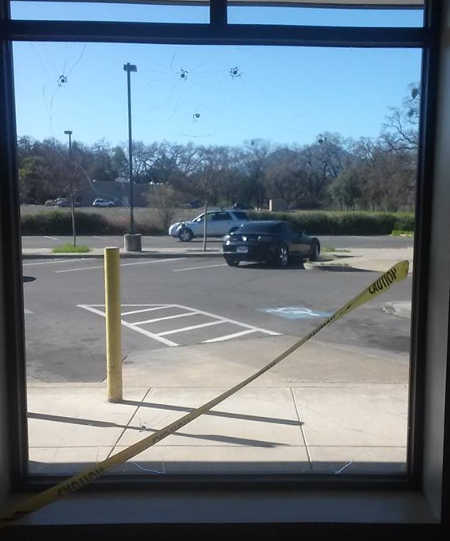 The windows at the post office on Olympic Drive in Clearlake, Calif., were damaged by a BB gun sometime on the night of Sunday, February 22, or early Monday, February 23, 2015. Photo by Miguel Cervantes. 022315cervantespostoffice2