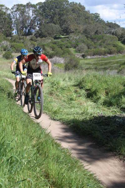 Nathan Barnett passing by a vernal pool at a NorCal Cycling League race in Seaside, Calif., on Sunday, March 1, 2015. Photo courtesy of Jeffrey Cramer. 030115bikebarnett
