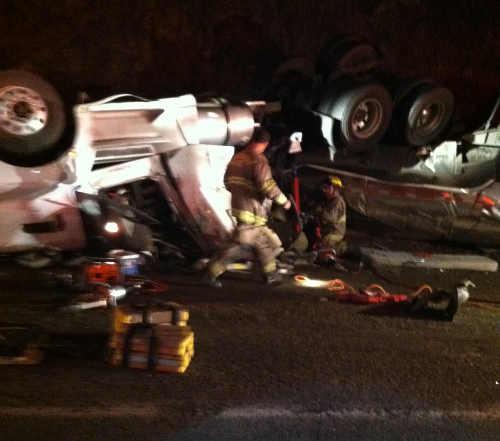 A Northshore Fire Protection District firefighter working at the scene of a semi truck rollover which occurred on Highway 20 near Lucerne, Calif., on Saturday, March 28, 2015. Photo courtesy of Pat Brown. 032815semicrash1