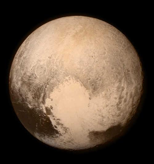 Pluto nearly fills the frame in this image from the Long Range Reconnaissance Imager (LORRI) aboard NASA’s New Horizons spacecraft, taken on July 13, 2015 when the spacecraft was 476,000 miles (768,000 kilometers) from the surface. This is the last and most detailed image sent to Earth before the spacecraft’s closest approach to Pluto on July 14. The color image has been combined with lower-resolution color information from the Ralph instrument that was acquired earlier on July 13. This view is dominated by the large, bright feature informally named the “heart,” which measures approximately 1,000 miles (1,600 kilometers) across. The heart borders darker equatorial terrains, and the mottled terrain to its east (right) are complex. However, even at this resolution, much of the heart’s interior appears remarkably featureless—possibly a sign of ongoing geologic processes. Credits: NASA/APL/SwRI. 071415spacenewspluto