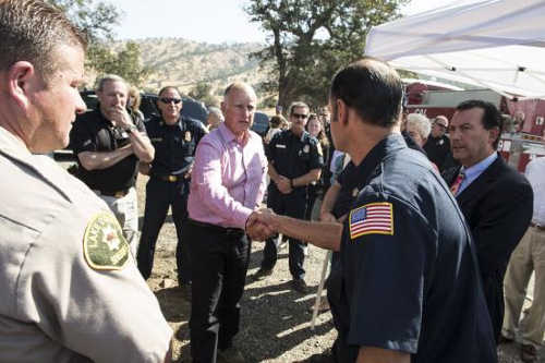 On Thursday, August 6, 2015, in Colusa County, Calif., Gov. Jerry Brown greets firefighters and emergency personnel – here, he shakes hands with Northshore Fire Protection District Chief Jay Beristianos as Lake County Sheriff Brian Martin and Clearlake City Manager Greg Folsom look on – after a briefing from Cal Fire Ken Director Pimlott on the status of firefighting efforts on the Rocky fire, which has burned nearly 70,000 acres in Lake, Colusa and Yolo counties since Wednesday, July 29, 2015. Photo Credit: Brad Alexander, Governor’s Office of Emergency Services. 080615rockyfirejay
