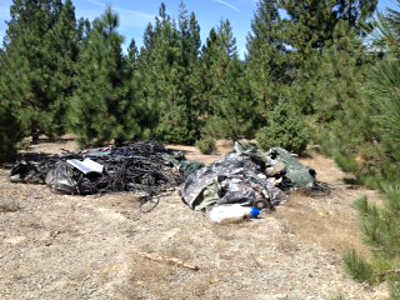 Trash and growing supplies found by officials while raiding marijuana gardens in the Mendocino National Forest in Glenn County, Calif., on Tuesday, August 19, 2014. Photo courtesy of the Glenn County Sheriff's Office. 081914mnfpotgrow