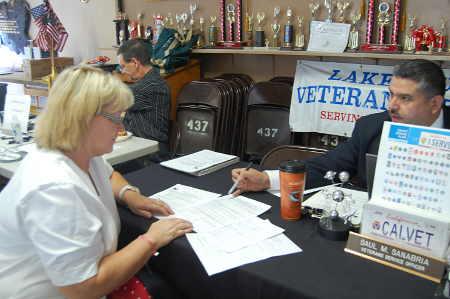 Lake County Veteran Service Officer Saul Sanabria works with Cindy Sobel at the Veterans Stand Down event on Thursday, September 11, 2014, in Clearlake, Calif. Photo by John Lindblom. 091114standdowntable