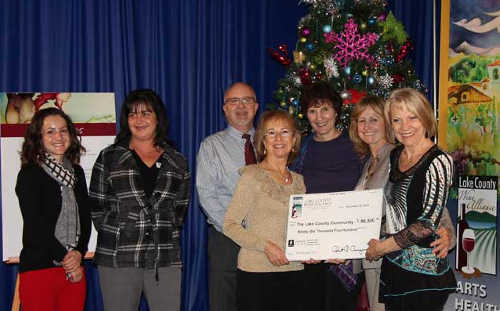 Lake County Wine Auction Directors Sharron Zoller and Judy Luchsinger sponsors who supported the 2014 Wine Auction during a reception on Thursday, December 11, 2014, in Lakeport, Calif. Photo courtesy of the Lake County Wine Alliance. 121114lcwacheck3