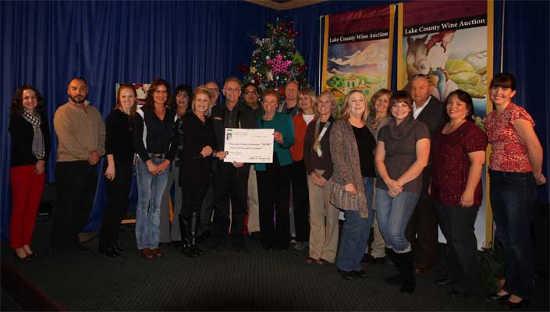Lake County Wine Auction Treasurer Rob Roumiguiere, sponsors, and representatives from this year's beneficiaries gather for distribution the proceeds from the 2014 Lake County Wine Auction on Thursday, December 11, 2014, in Lakeport, Calif. Photo courtesy of the Lake County Wine Alliance. 121114lcwachecks2
