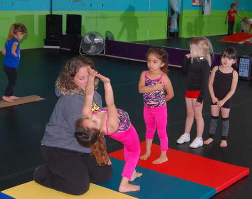 Danita Shook working with her young students on tumbling skills. Courtesy photo. cheerleadingtumbling