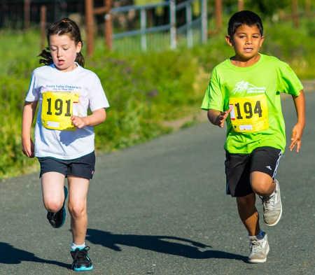 Two children it out in the children's one-kilometer run at a past 'Spring Has Sprung' running event in Hidden Valley Lake, Calif. Photo courtesy of the Lake County Milers Walking and Running Club. hvlmilerskids