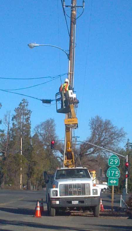 A Mediacom truck continued repairs on Friday, January 18, 2013, at the site in Kelseyville, Calif., where a vehicle sheared off a power pole on Thursday, January 17, 2013. Photo by Casse Waldman Forczek. 011813polerepair