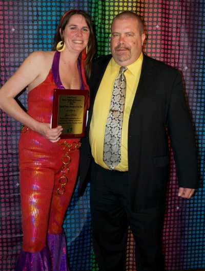 Lakeport Chief of Police Brad Rasmussen, presents the award for Outstanding Special Needs Inclusion to Jami White from Early Head Start at the 2012 disco-themed award dinner. Photo courtesy of the Lake County Child Care Planning Council. rasmussenchildcareaward