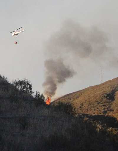 A Cal Fire helicopter drops fire on the Double Fire near Clearlake Oaks, Calif., on Friday, August 16, 2013. Photo by Rhondee Mullins. 081613doublefiremullins