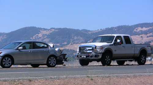 A silver Honda sedan and a white Ford pickup were involved in a crash in Lucerne, Calif., on Sunday, August 18, 2013. Not pictured is the third vehicle involved, a green Pontiac. Photo by John Jensen. 081813jjlucernecrash2