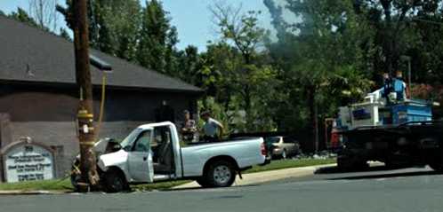Following a pickup crash with a power pole on 11th Street in Lakeport, Calif., on Tuesday, July 2, 2013, the roadway was scheduled to remain closed for several hours as Pacific Gas and Electric crews worked on the damaged pole. Photo by Doug Rhoades. 070213pickupcrash