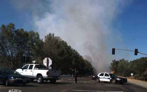 Clearlake Police blocked off Highway 53 and Olympic Drive in Clearlake, Calif., on Saturday, July 13, 2013, in response to a wildland fire. Photo by Cheryl Johns. 071313cpddenton