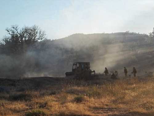 Firefighters and a bulldozers work at the scene of a wildland fire in Spring Valley east of Clearlake Oaks, Calif., on Saturday, July 27, 2013. Photo by Linda Stapleton. 072713springfiredozersls