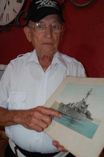 Korean War veteran Griff Ratterree of Clearlake, Calif., with a picture of the destroyer John W. Thomason, which he served on during the war. Photo by John Lindblom. griffratterree