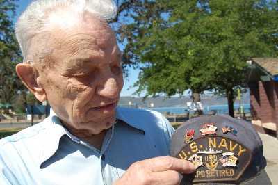 Harry Graves of Clearlake, Calif., served in the Navy during three wars – World War II, Korea and Vietnam. Here he points to the commemorative pins for his service on his hat. Photo by John Lindblom. harrygravesandhat