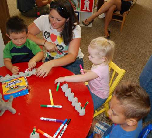 Laura Pimentel instructs a group of youngsters making egg carton caterpillars at the new Middletown Library in Middletown, Calif., as part of the 2013 Children's Summer Reading Program. Photo by John Lindblom. mtownreadingeggcrates