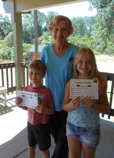 Ellie Augustinovich and Aden Besgrove receive their “Rodman Explorer” certificates from nature education specialist Elaine Mansell for participating in the Lake County Land Trust’s Children’s Nature Education Program in Lake County, Calif. Courtesy photo. natureexplorerskids