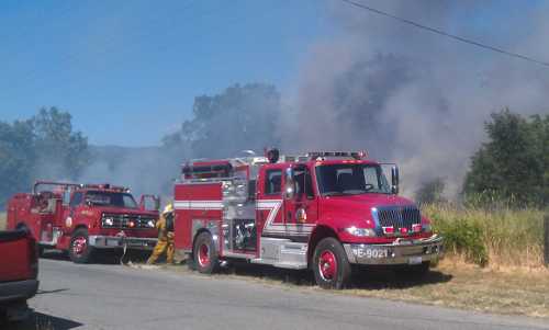 Firefighters at the scene of a small vegetation fire near Upper Lake, Calif., on Thursday, June 13, 2013. Photo by Elizabeth Larson. 061313mockingbirdtrucks
