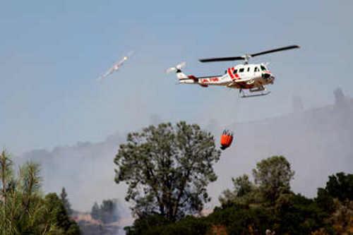 A Cal Fire copter and a Cal Fire air attack plane work the Mount Fire on Konocti Road in Kelseyville, Calif., on Thursday, June 20, 2013. Photo by Gail Salituri. 062013salituricopter2