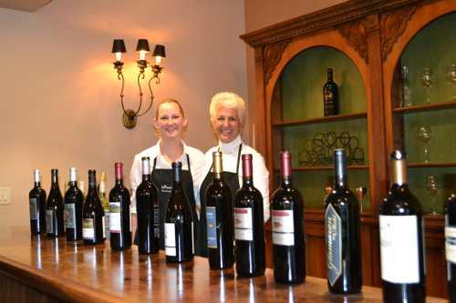 Staff of Bellissimo! Wine Country Catering prepare to pour LCWA member wines for guests at Brassfield Estate Winery near Clearlake Oaks, Calif., on Thursday, February 21, 2013. Photo by Casey Carney. 022113lcwaevent2