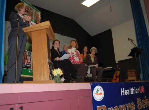 Shelley Tan, principal of Cobb Mountain Elementary School in Cobb, Calif., speaks to students and staff at a school assembly on Tuesday, March 19, 2013, for the presentation of the HealthierUS School Challenge Bronze Award. Photo by John Lindblom. 031913cobbfoodaward