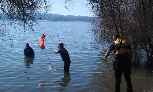 A Northshore Fire Protection District Dive Team member Keith Hoyt prepares to go into Clear Lake to help recover the pickup driven by Ann Adams of Lucerne, Calif., that went into Clear Lake on Thursday, March 21, 2013. Photo by Elizabeth Larson. 032113lucernepickupdivers