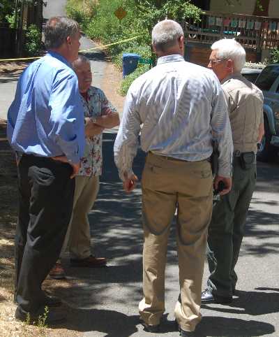 District Attorney Don Anderson (left), his investigators and Sgt. Dennis Ostini of the Lake County Sheriff's Office discuss a shooting incident involving what appears to be an accidental discharge of a California Highway Patrol officer's firearm during a struggle with a male subject that occurred on the morning of Thursday, May 30, 2013. Photo by John Lindblom. 053013jlandersonatscene