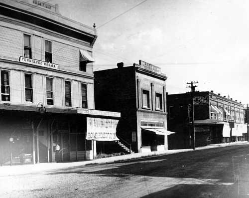 The May Building / Piner Apartments, on the left, burned on June 26, 1925. The wooden exterior stairway on the building that housed the Davis & Patten store and the Odd Fellows Hall burned, but a steel door at the top kept the fire out of the building. Courtesy of Lake County Museum. 1920slakeportmaybuilding