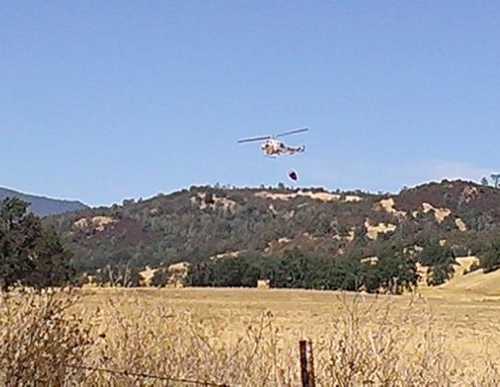 Johanna Leuzinger took this picture of a Cal Fire helicopter taking water to a fire on Big Canyon Road near Middletown, Calif., on Tuesday, September 3, 2013. 090313leuzingercopter