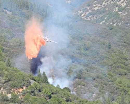 A Cal Fire air tanker drops retardant on a small wildland fire near Lakeport, Calif., on Thursday, September 19, 2013. Courtesy photo. 091913cowfiretanker