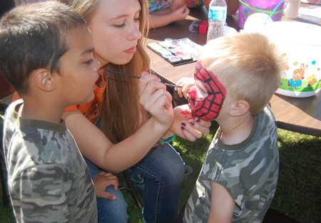Terry Sage, 4, gets his face painted by Karmen Jacobs as Alex Kawpimulk looks on at the First Assembly of God Community Easter Egg Hunt on Saturday, April 19, 2014, in Clearlake, Calif. Photo by John Lindblom. 041914sagefacepaint