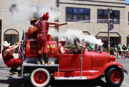 The Lake County Fire Protection District makes its way through town on an antique fire truck during the Lower Lake Daze Parade on Sunday, May 25, 2014, in Lower Lake, Calif. Photo by Denise Rockenstein. 052514paradefireguys