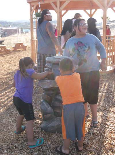 Children enjoy the found in the new garden on the Lake County Tribal Health Consortium grounds in Lakeport, Calif., on Thursday, May 29, 2014. Photo by Elizabeth Larson/Lake County News. 052914tribalgardenkids