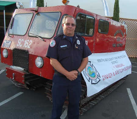 South Lake County Fire Protection District Captain Tony Allegra, who also is president of the South Lake County Volunteer Firefighter Association, said the association's fundraiser on Friday, June 20, 2014, was very successful. Here he's shown with a 1964 all-terrain vehicle which is still in use for evacuating people in the snow of Cobb and Mendocino County above Upper Lake. Photo by John Lindblom. 062414allegrapic