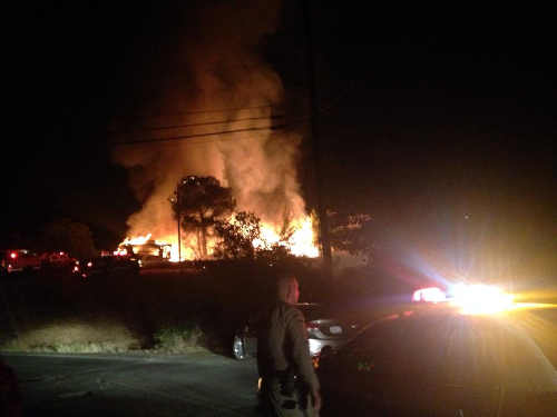 Law enforcement officers were on scene to help control traffic around a residential fire in Nice, Calif., that began late on the night of Saturday, August 2, 2014. Photo courtesy of Selena Stevenson. 080314nicefire