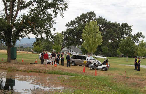 Law enforcement and fire officials at the scene where a body was discovered in a pond on the golf course in Hidden Valley Lake, Calif., on Monday, August 4, 2014. Photo by John Lindblom/Lake County News. 080414hvlbody1