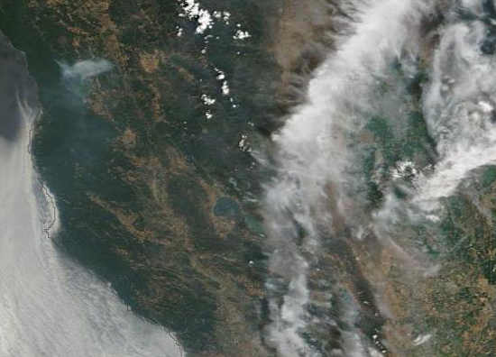 Satellite imagery showing a layer of smoke over Northern California on Wednesday, August 6, 2014. Clear Lake is the green water body in the center of the image, near a line of clouds. Image by the National Aeronautics and Space Administration/MODIS. 080614smokesatellite