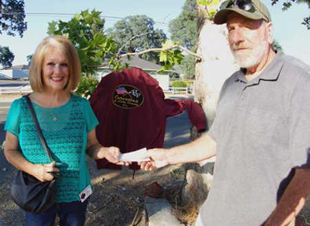 Gail Salituri, founder of the Barbara LaForge Memorial Fund, a member of Corvettes of Lake County and a Lake Family Resource Center board member, accepts a $1,500 donation from Corvettes of Lake County Treasurer Mike Beall over Memorial Day weekend 2014. Photo by John Yde. 2014laforgedonation