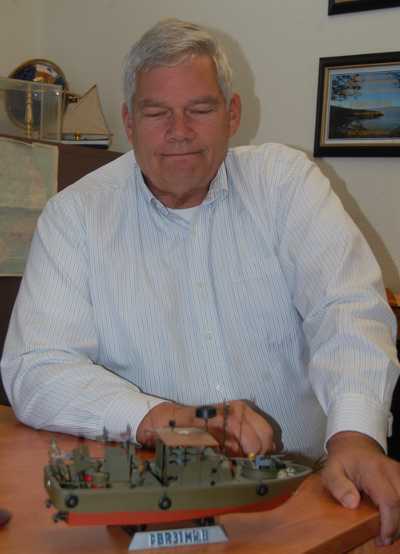 Lake County, Calif., Veterans Service Officer Bob Penny looks at a model of a PBR (patrol boat, river) used by the Navy in Vietnam and which he was aboard when he was injured. He's retiring from his post on Tuesday, April 1, 2014. Photo by John Lindblom. bobpennyboat
