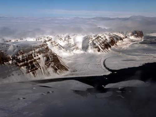 This image depicts the view of mountains and sea ice near Thule Air Base, Greenland, from the NASA P-3 on May 6, 2014. Credit: NASA/Michael Studinger. nasathuleice