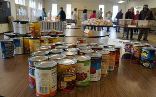Tables in the center of the Kelseyville Presbyterian Church Fellowship Hall are stacked with staples for the Kelseyville Food Pantry giveaway on Tuesday, January 26, 2016, in Kelseyville, Calif. Photo by Elizabeth Larson/Lake County News. 012616kfpselections