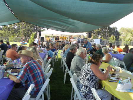 Enjoying dinner at the sixth annual Grillin’ on the Green barbecue on Saturday, August 1, 2015, in Lakeport, Calif. Photo by Susan Stout. 080115grillingeating