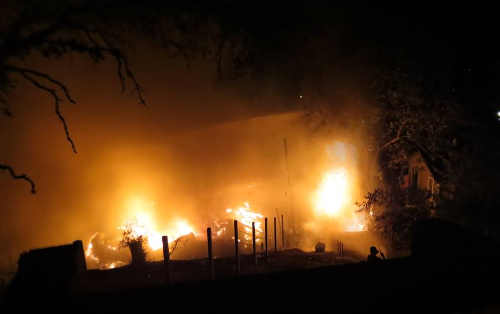 A structure fire in Nice, Calif., on Monday, August 17, 2015, destroyed two homes and an outbuilding. Photo courtesy of Sheila Gatton. 081715sheilagattonnicefire