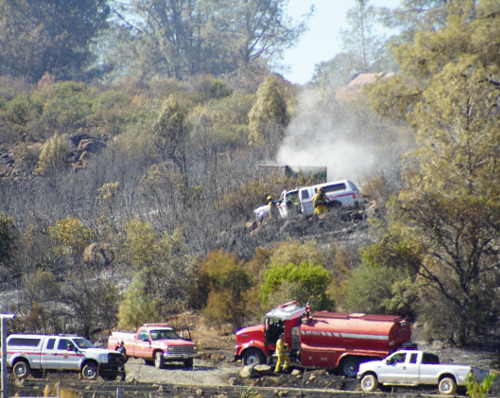 Firefighters work on hot spots at the scene of the Grade fire, located northeast of Middletown, Calif., which began on Monday, August 24, 2015. Photo by Elizabeth Larson/Lake County News. 082415elgradefire2