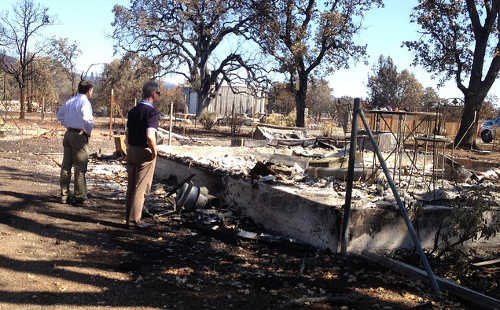 California Insurance Commissioner Dave Jones (left) views some of the damage of the Valley fire in Lake County, Calif., on Friday, September 18, 2015. Photo courtesy of the California Department of Insurance. 091815jonesvalleyfirevisit
