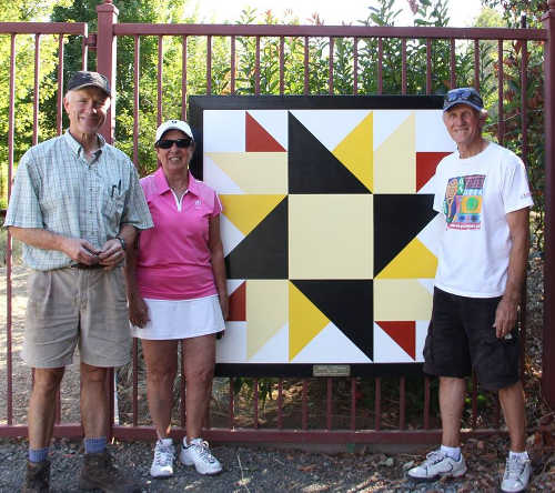 From left, Gregory Graham, Madeline Wenn-Murphy and Jay Murphy with the “Jody’s Sunflower” quilt block on the Lake County Quilt Trail. Photo courtesy of the Lake County Quilt Trail. lcqtjodysunflower