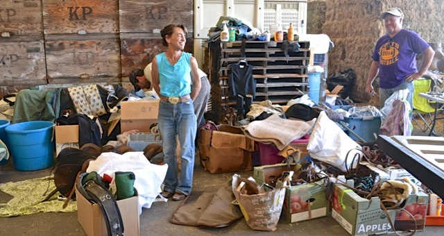 Shoreline Riders of Fort Bragg, Calif., made a generous donation to help Valley fire victims in Lake County, Calif. Rosalie Caesari drove three and a half hours to deliver saddles, blankets, bridles, show halters, girths, saddle pads, equine supplements and more. Above, Caesari chats with Kit Huston who was thrilled to find saddle pack bags brought by a member of Shoreline Riders, who wondered if anyone would want them. It turned out the bags were just the thing Huston wanted. Photo courtesy of SAFER. safershorelineridersedit