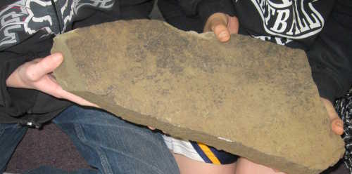 A fragment of a large Miwok Indian milling stone unearthed years ago when the Hidden Valley Lake Water District plant was being constructed near Middletown, Calif."s Crazy Creek area. The artifacts are determined by archaeologists to be more than 7,000 years old. Photo by Kathleen Scavone. scavonemillingstone