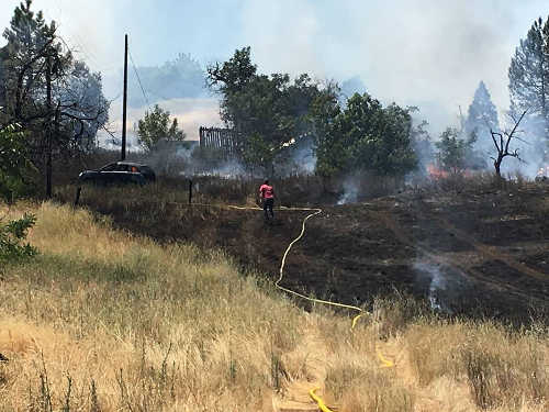 The fire burned between Lakeview Apartments and Highway 29 on Tuesday, July 12, 2016, in Lakeport, Calif. Photo by Jerome Strach. 071216strachlakeportfire